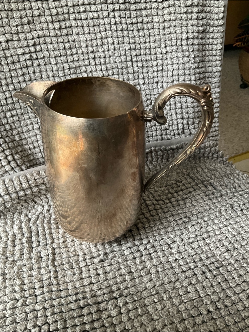 Polished Silver-Tone Decorative Metal Pitcher with Ornate Handle